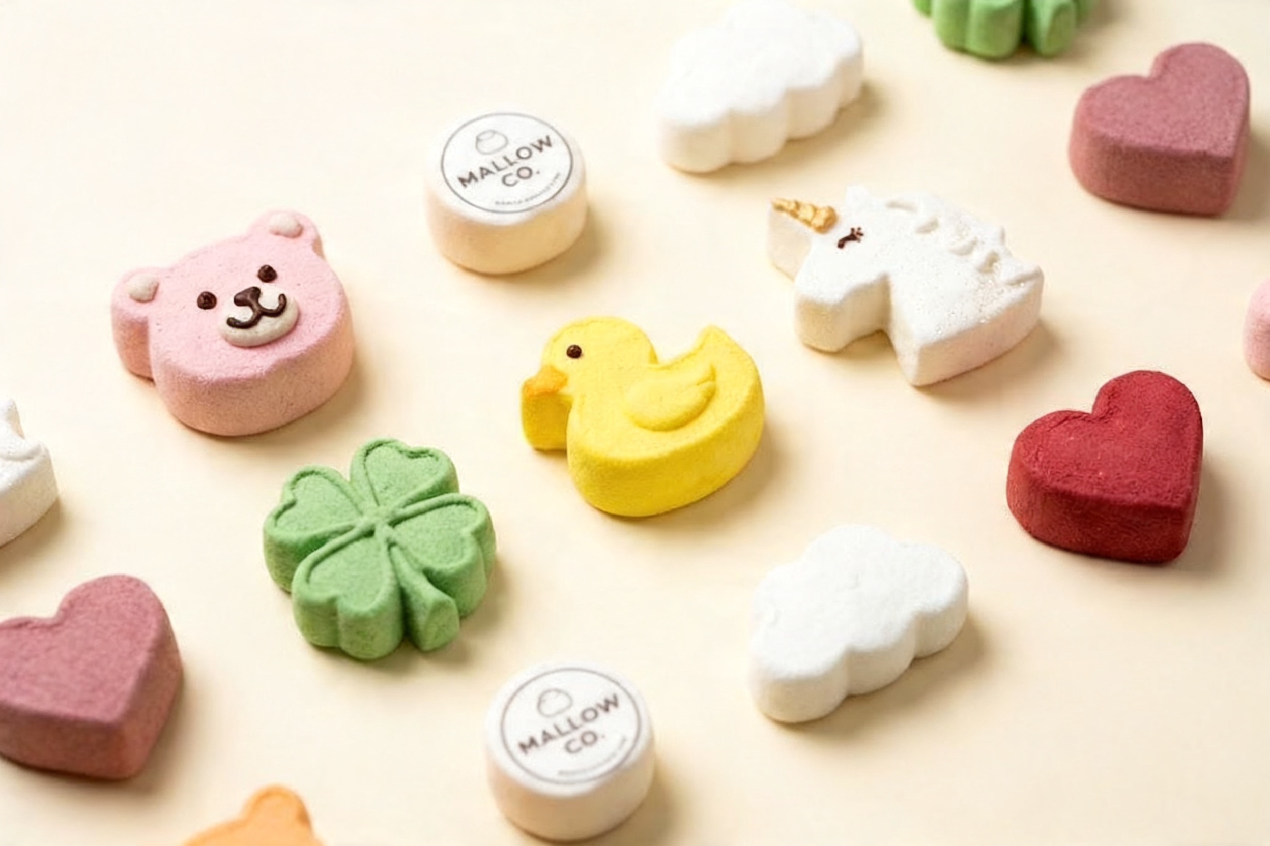 A collection of colorful custom shaped marshmallows, including animals and logos.